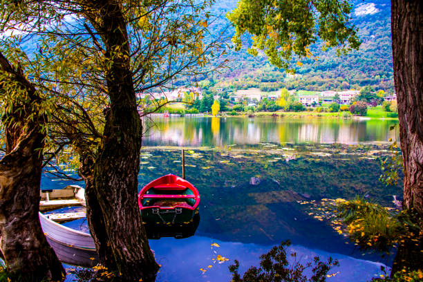 romantically abandoned red and white boats on the shores of the Revine lakes, Treviso, Italy