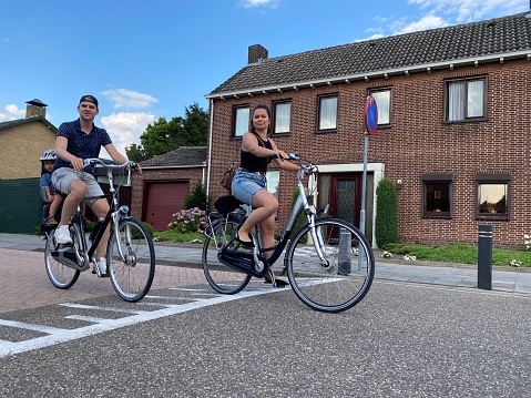 Brunssum, the Netherlands, -July 28, 2020. Young Family making a trip on the bicycle on a sunny Sunday morning in July.