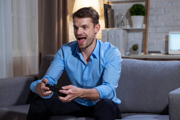 istock Happy young man playing a video game. 1281933127