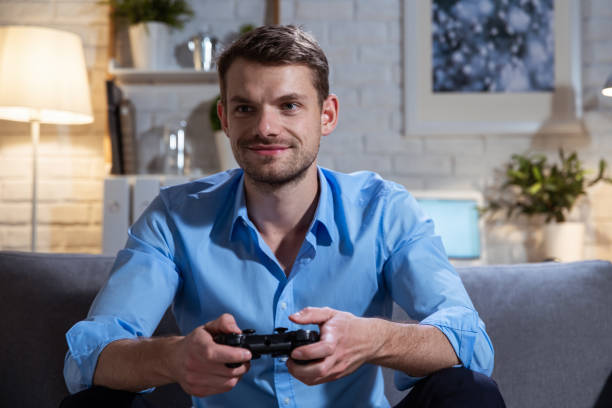 istock Attractive man plays a video game, home alone. 1281933791