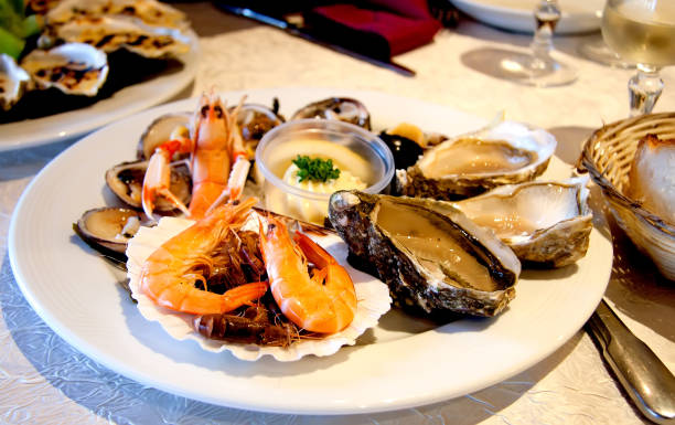 prato de frutos do mar fresco com lagosta, camarões e ostras sobre a mesa - camarão marisco - fotografias e filmes do acervo
