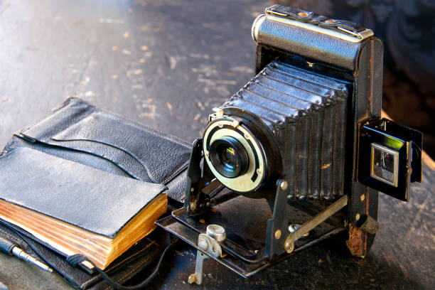 istock retro camera on the black background with slides 1281934801