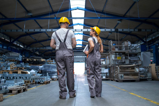 istock Industrial workers standing in factory. 1281934971
