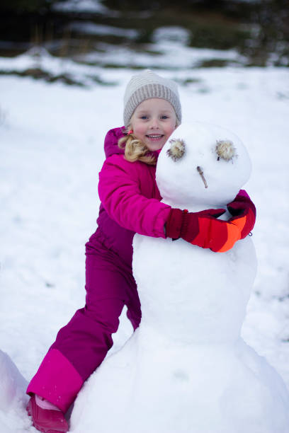 istock little girl having fun with snow 1281935654