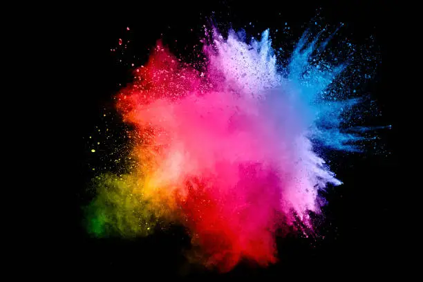 Photo of Colorful background of pastel powder.Multi colored dust splash on black background.Painted Holi.