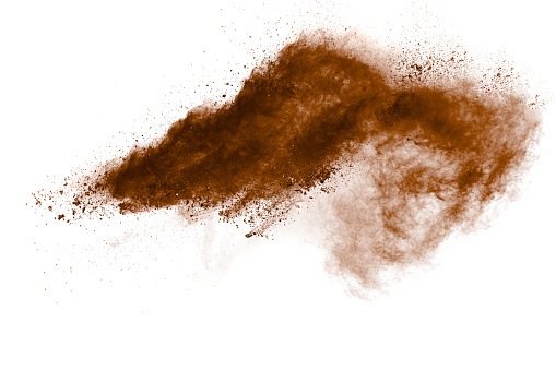 Freeze motion of brown dust explosion. Stopping the movement of brown powder. Explosive brown powder on white background.