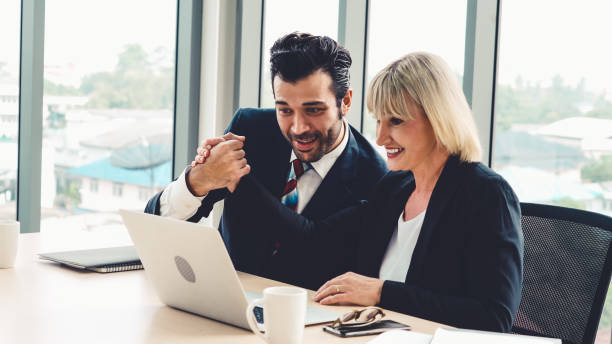 istock Two happy business people celebrate at office 1281936619