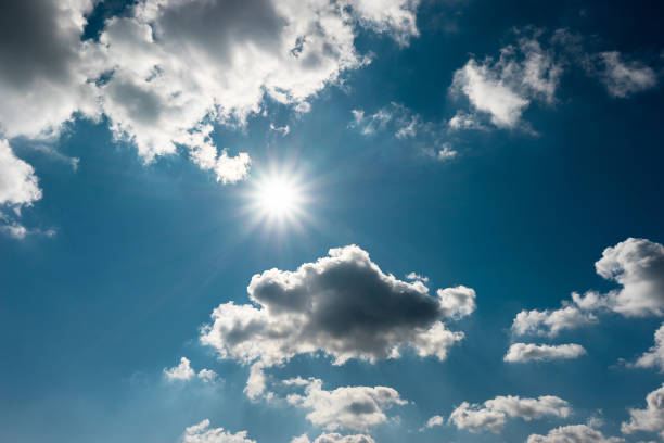 Blue sky with  clouds and sun stock photo