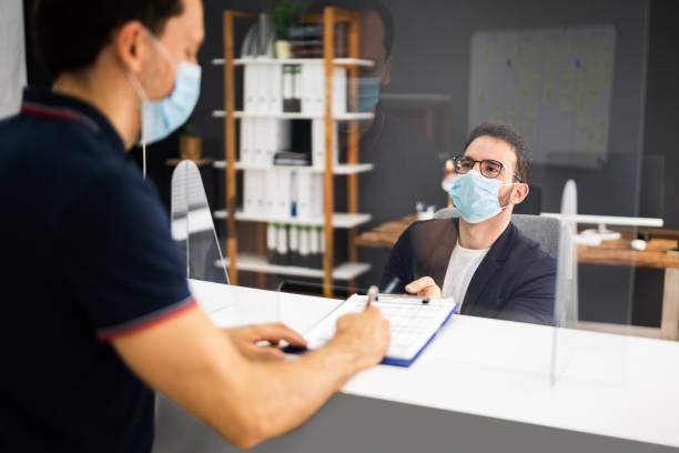istock Hotel Reception Desk Protected By Medical Mask 1281940133
