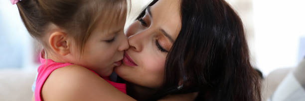 istock Mother kissing little child 1281942816