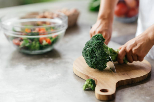 istock Human hands cooking vegetables salad in kitchen 1281947263