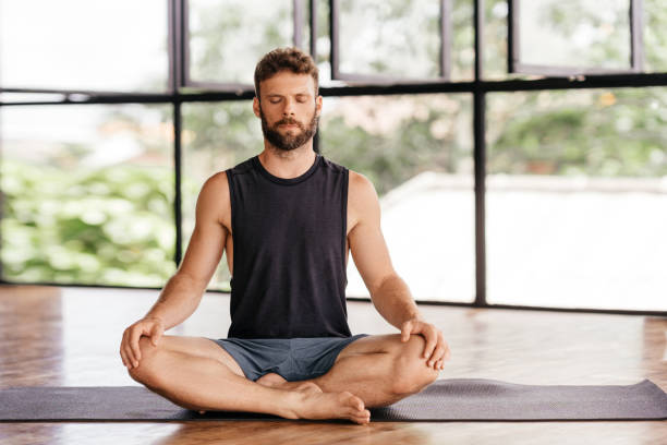 istock Yoga men workout in studio in front of a window 1281947321