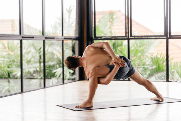 istock Yoga men workout in studio in front of a window 1281947337