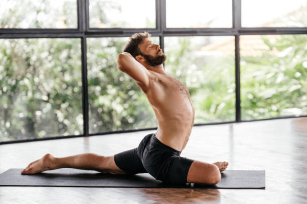 istock Yoga men workout in studio in front of a window 1281947349