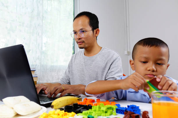 istock A father learning online ,with a son at home 1281947454