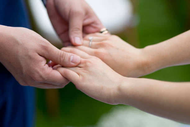 istock Midsection Of Bride And Groom Holding Hands While Standing Outdoors 1281950789