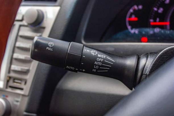 istock car windshield rain wiper control switch close up. Wipers control. Modern car interior detail. adjusting speed of screen wipers in car 1281951724
