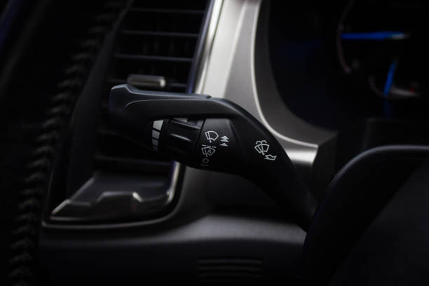 istock car windshield rain wiper control switch close up. Wipers control. Modern car interior detail. adjusting speed of screen wipers in car 1281951789