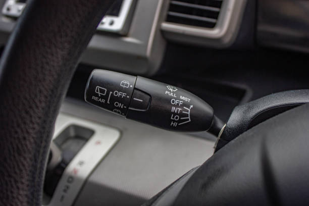 istock car windshield rain wiper control switch close up. Wipers control. Modern car interior detail. adjusting speed of screen wipers in car 1281951807