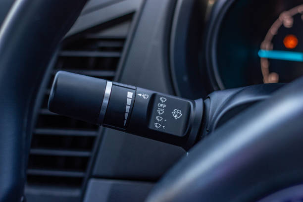 istock car windshield rain wiper control switch close up. Wipers control. Modern car interior detail. adjusting speed of screen wipers in car 1281951851