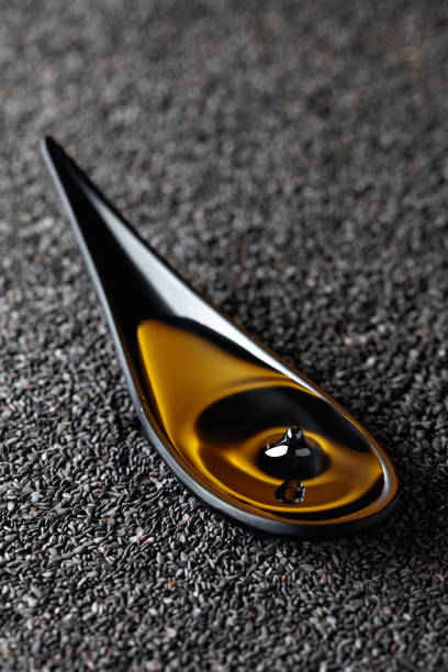 istock Sesame oil and raw black sesame seeds. 1281951901