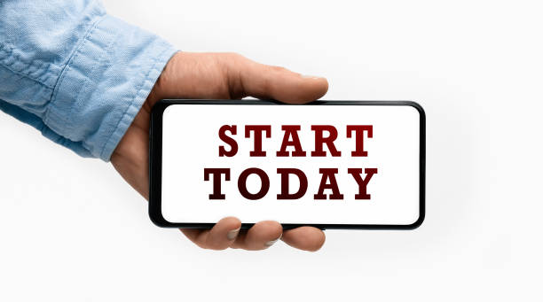istock Closeup of a male hand holding Smartphone with text START TODAY on display 1281952857