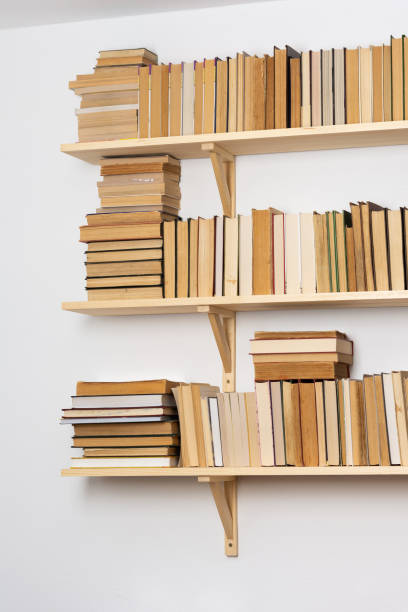 istock Bookshelves with hardback overturned books 1281954250