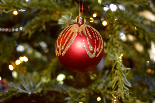 istock Red ball ornament hanging on a pine tree, Christmas tree decoration. 1281955126