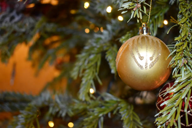istock Golden ball ornament hanging on a pine tree, Christmas tree decoration. 1281955134