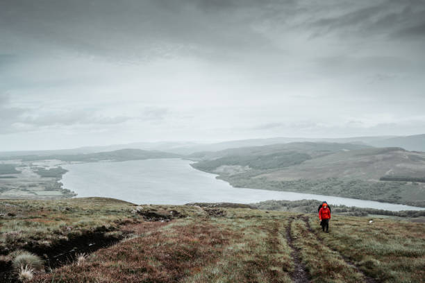 istock Tourist hikes a heather-covered hill 1281956261