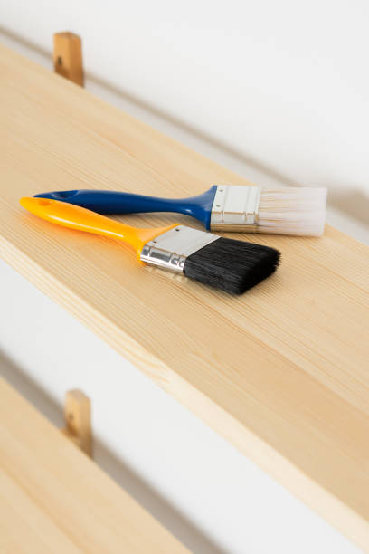 istock Paint brushes are on a wooden shelf 1281956350
