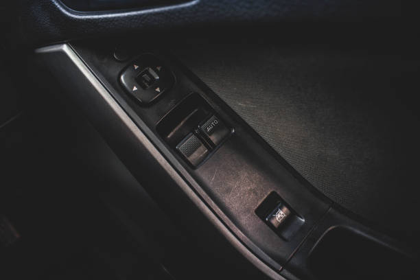 istock Car arm rest with Control Panel. Door Lock & Mirror Control. window adjustment buttons, door lock. Photography of a modern car. 1281957575