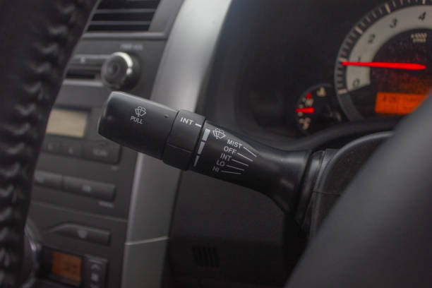 istock Windscreen wiper control switch in car. Wipers control. Modern car interior detail. adjusting speed of screen wipers in car. 1281957576