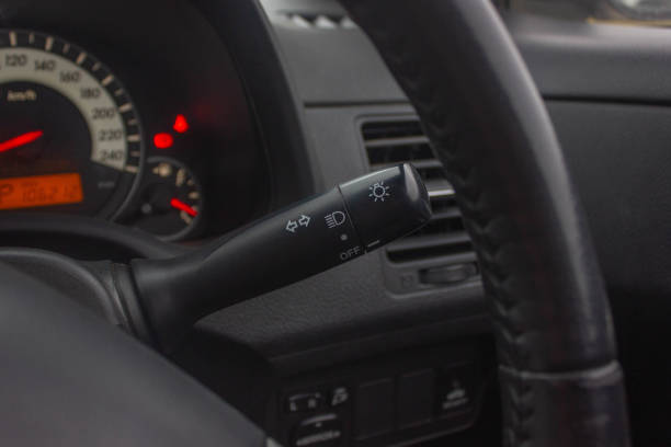 istock Switch off lights in a car. close-up Car integrated turning indicator with headlight switch toggle. 1281957586