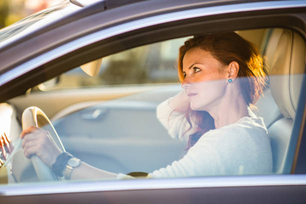 istock Pretty, young woman  driving a car 1281958580
