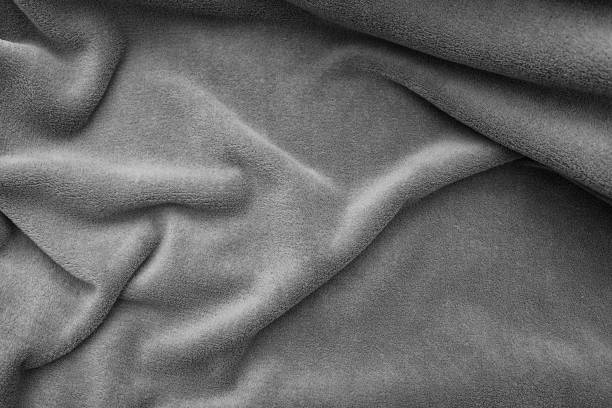 istock Fleece. Close-up warm, softness grey plaid on the bed, top view. Crumpled soft blanket. 1281960686