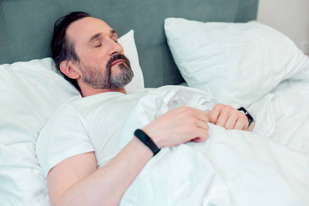 istock Bearded handsome man resting in his bed at home 1281960895