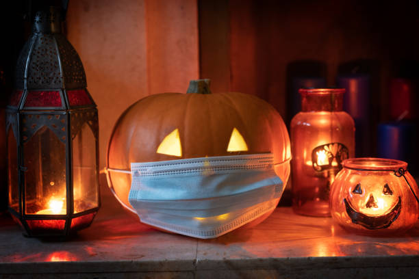 istock Jack lantern Halloween pumpkin wearing mask during coronavirus lockdown. 1281960940