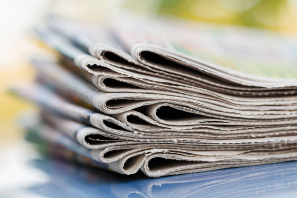 istock Time to read concept. Newspapers folded and stacked on the blue surface and blur background. Closeup, selective focus 1281961617