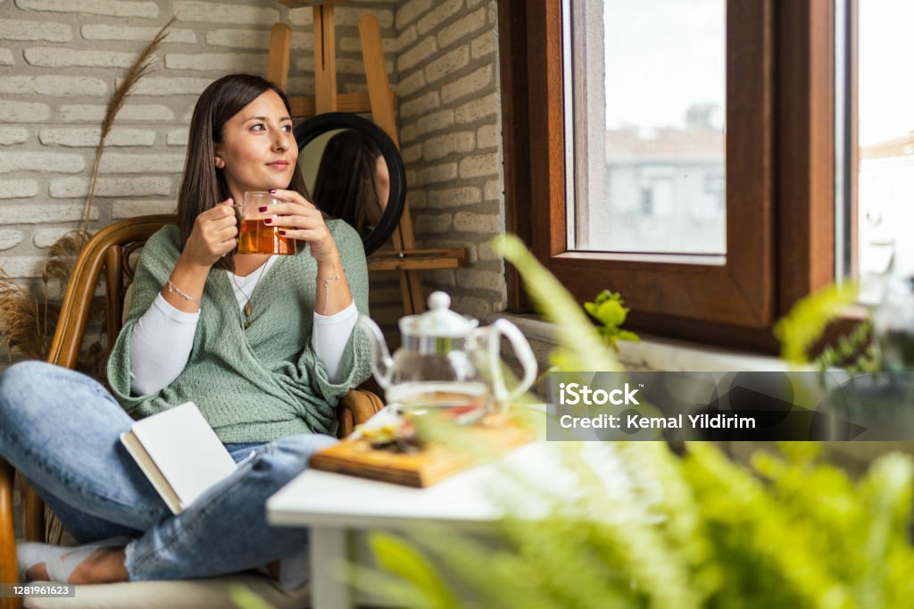 Young Woman drinking her winter tea and welcoming new day Herbal Tea Stock Photo