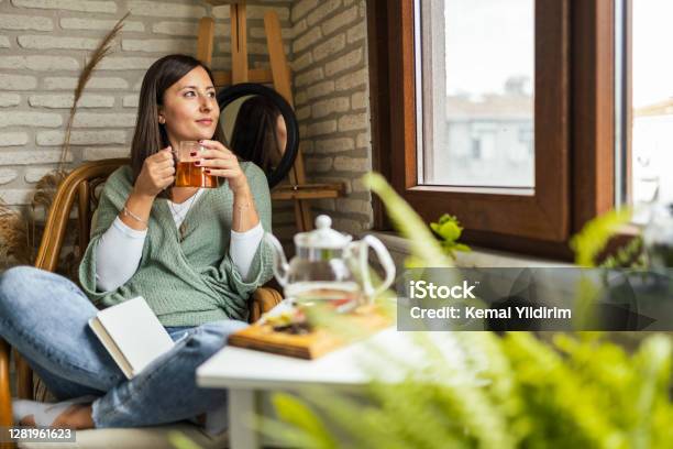Young Woman Drinking Her Winter Tea And Welcoming New Day Stock Photo - Download Image Now