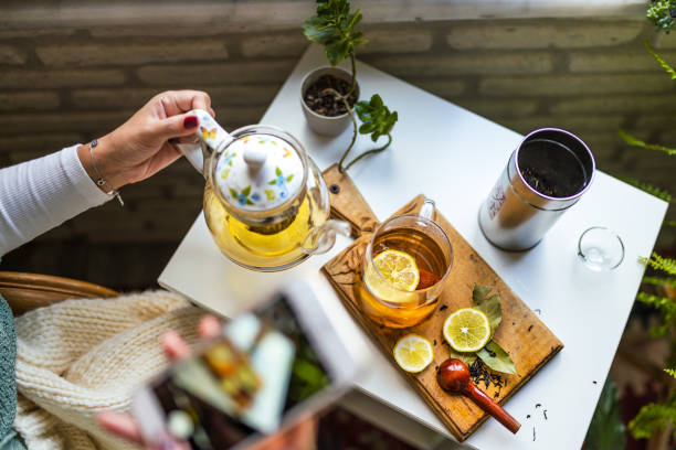 아늑한 차 가게에서 허브 차를 마시는 클로즈업 젊은 여성 - herbal tea 이미지 뉴스 사진 이미지