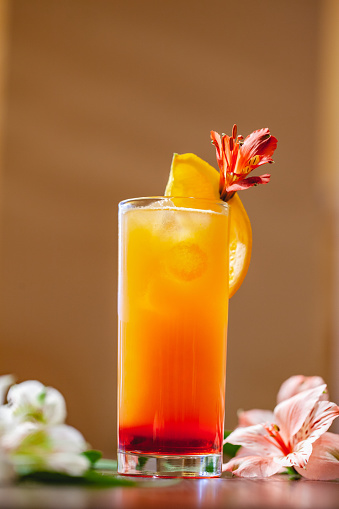 Tequila sunrise cocktail on wooden table. Close up