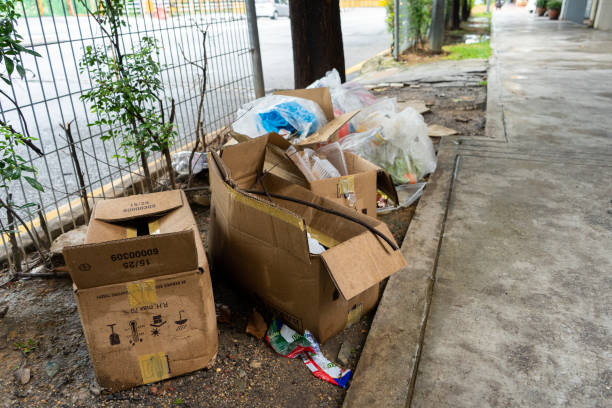 Mountain of garbage and cardboard boxes on the street. The problem of garbage collection. The irresponsibility of people. Mountain of garbage and cardboard boxes on the street. The problem of garbage collection. The irresponsibility of people. Kuala Lumpur , Malaysia - 04.06.2020 overflowing trash dumpster stock pictures, royalty-free photos & images