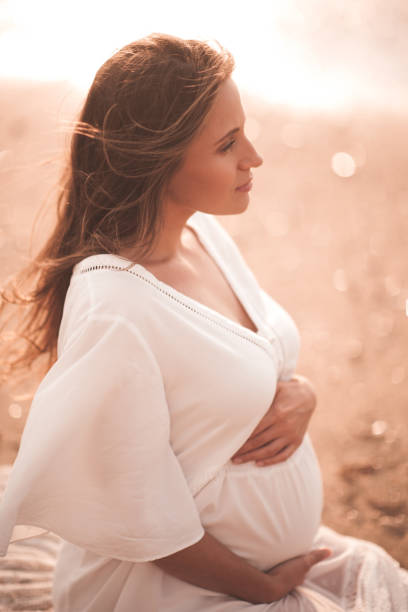 istock Pregnant woman outdoors over sea 1281968156