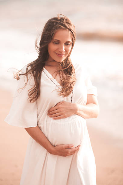 istock Pregnant woman outdoors over sea 1281968157