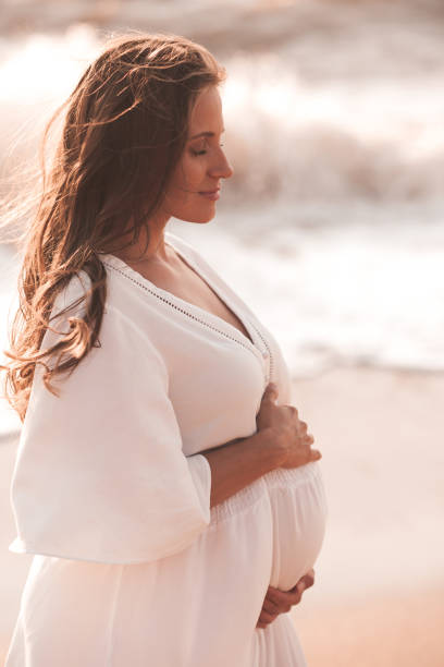 istock Pregnant woman outdoors over sea 1281968178