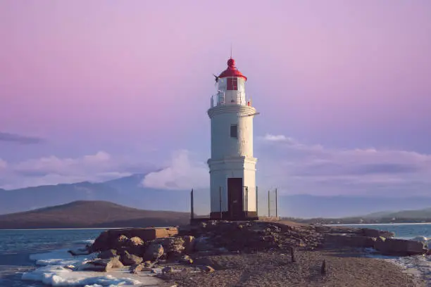 Seascape overlooking The Tokarev lighthouse against the pink sky. Vladivostok, Russia