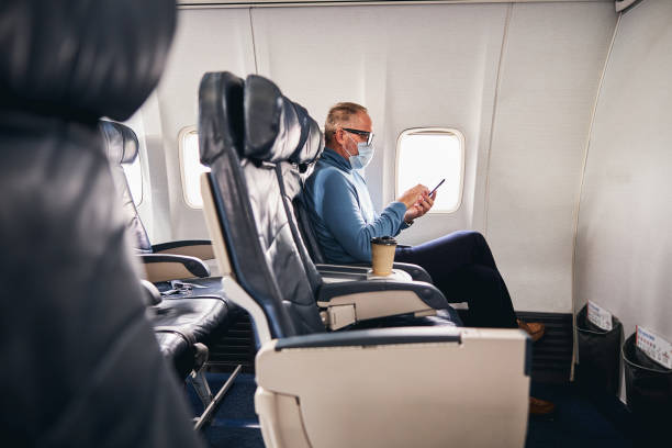 istock Concentrated businessman using his cellphone during the flight 1281970238