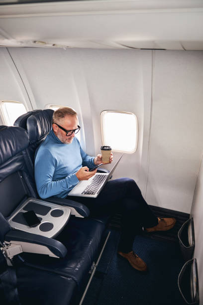 istock Concentrated airline passenger working during the flight 1281970276